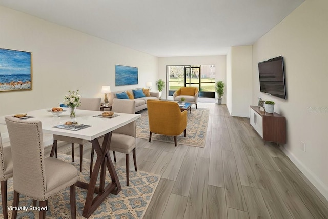 interior space featuring light wood-style flooring and baseboards