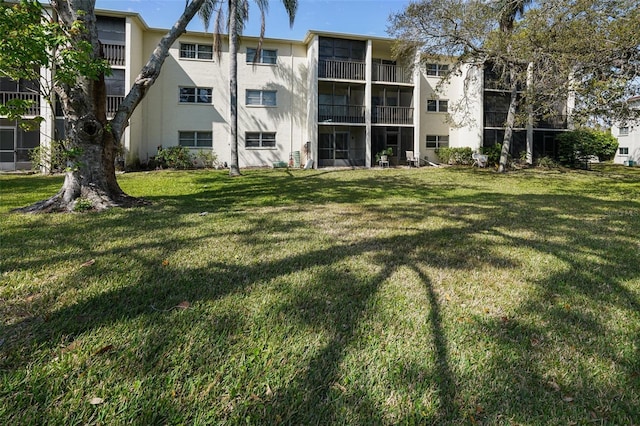 exterior space with a lawn and stucco siding