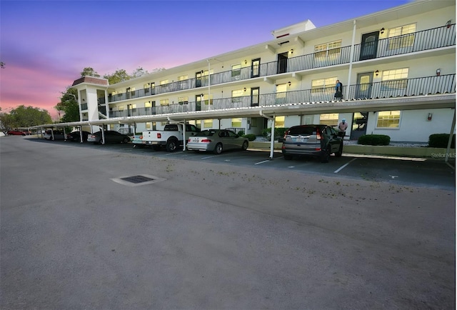 1375 Doolittle Ln Unit 103, Dunedin, FL 34698 - property at dusk featuring covered parking