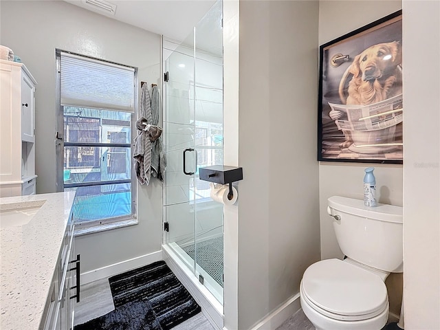 full bath featuring toilet, a shower stall, visible vents, and baseboards