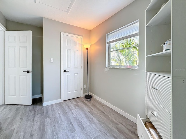 unfurnished bedroom featuring light wood-style flooring and baseboards