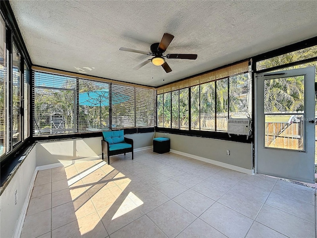 unfurnished sunroom with ceiling fan