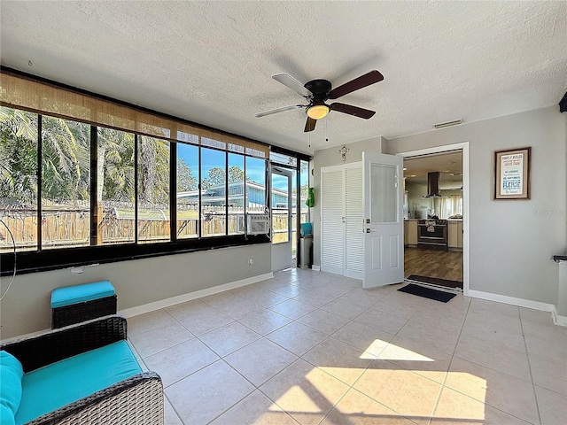 interior space with light tile patterned floors and a textured ceiling