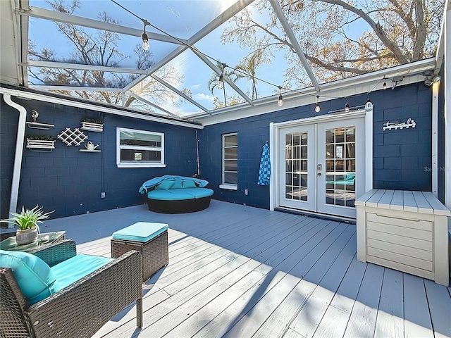 wooden deck with glass enclosure and french doors