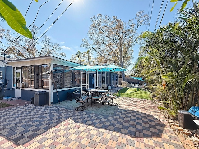 view of patio / terrace featuring a sunroom