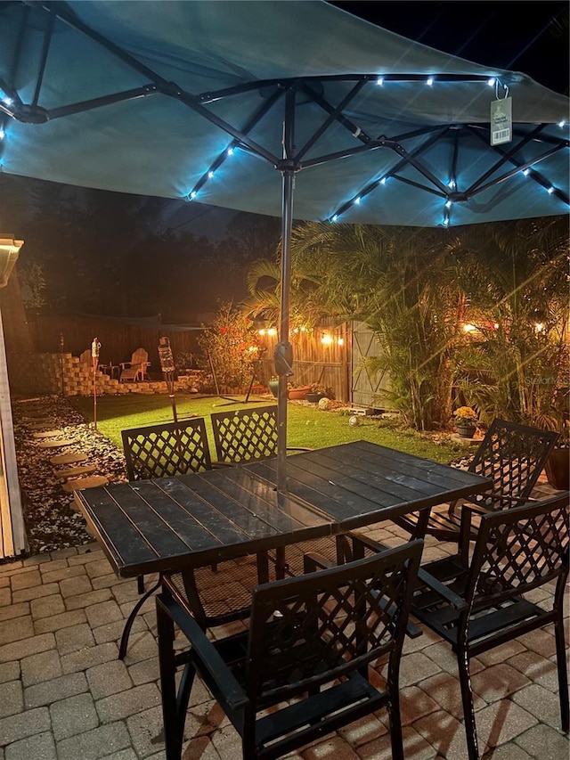 1859 Oklahoma Ave NE, Saint Petersburg, FL 33703 - patio at twilight with outdoor dining area and fence