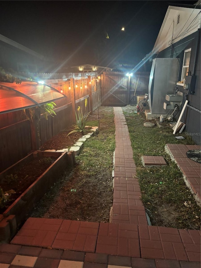 1859 Oklahoma Ave NE, Saint Petersburg, FL 33703 - yard at night with a fenced backyard