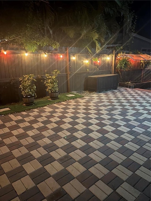 1859 Oklahoma Ave NE, Saint Petersburg, FL 33703 - patio at night with a jacuzzi and a fenced backyard