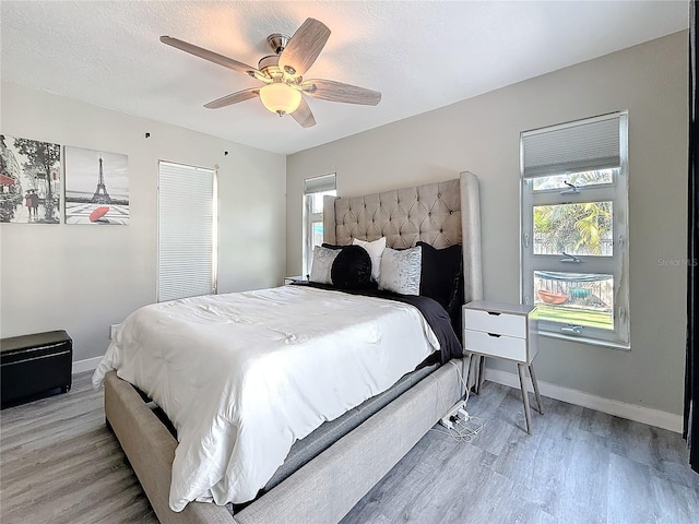 1859 Oklahoma Ave NE, Saint Petersburg, FL 33703 - bedroom featuring light wood-type flooring, a ceiling fan, baseboards, and a textured ceiling