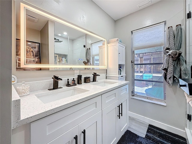 1859 Oklahoma Ave NE, Saint Petersburg, FL 33703 - full bath with double vanity, wood finished floors, and baseboards