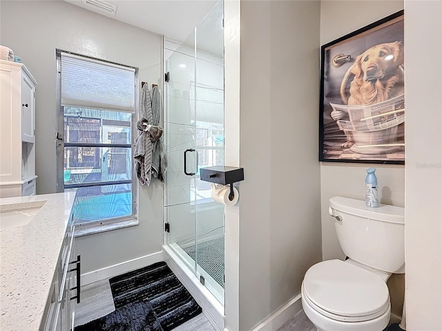 1859 Oklahoma Ave NE, Saint Petersburg, FL 33703 - bathroom featuring baseboards, a shower stall, toilet, and vanity