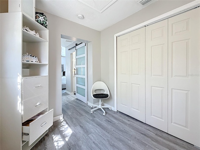 1859 Oklahoma Ave NE, Saint Petersburg, FL 33703 - bedroom featuring wood finished floors, a closet, baseboards, and attic access