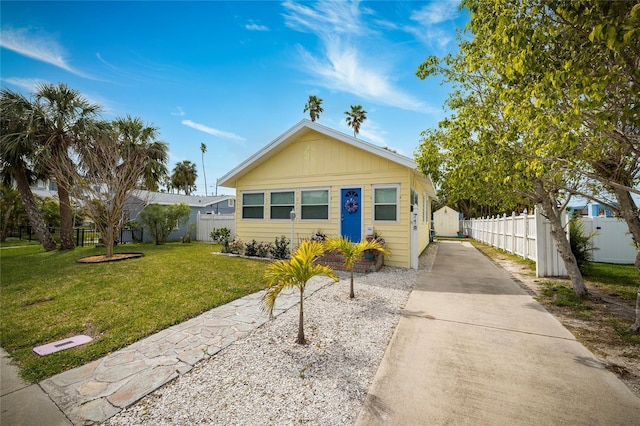 view of front of property with a front yard and fence