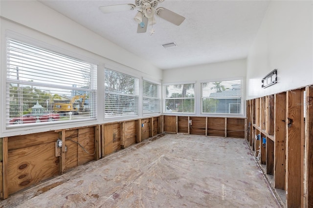 unfurnished sunroom with ceiling fan and visible vents