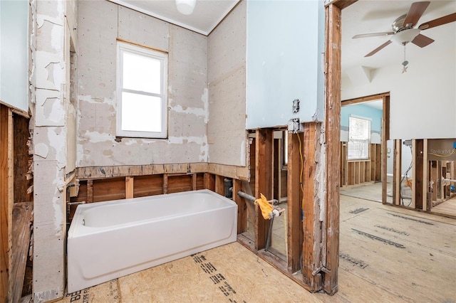 full bathroom with ceiling fan and a bathing tub