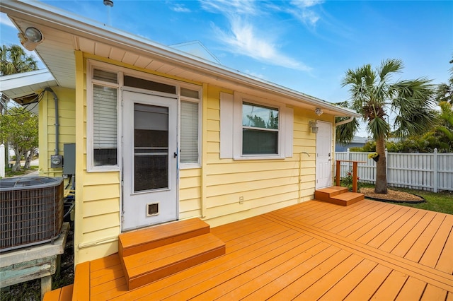 wooden deck featuring entry steps, fence, and central AC