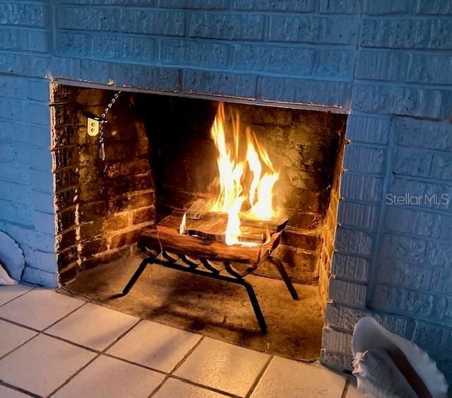 details with a fireplace and concrete block siding