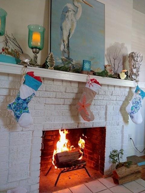 interior details featuring a brick fireplace