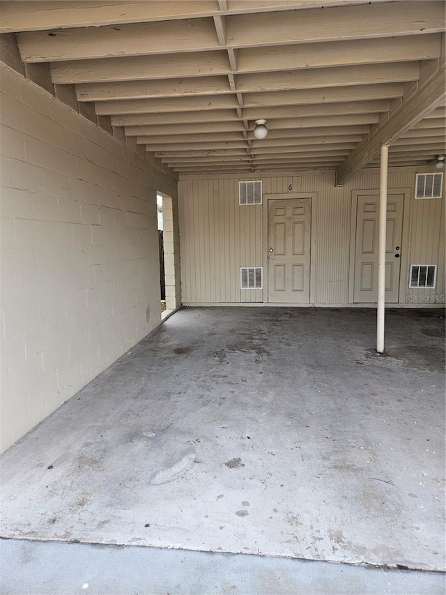 garage with concrete block wall and visible vents