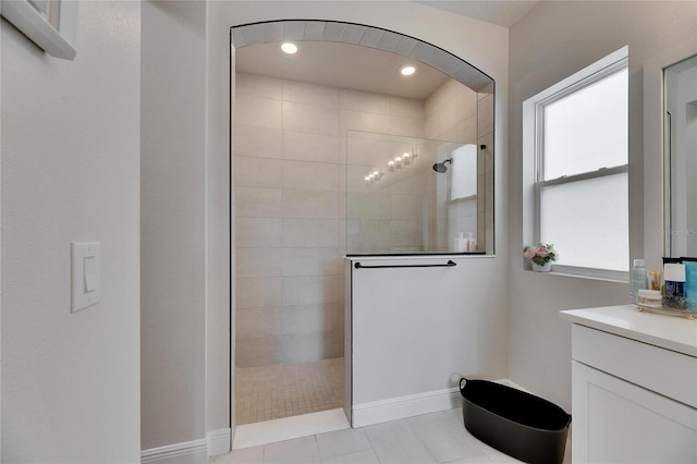 full bath with recessed lighting, vanity, baseboards, and a walk in shower