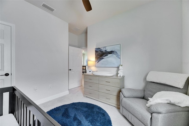 bedroom featuring a ceiling fan, light colored carpet, visible vents, and baseboards