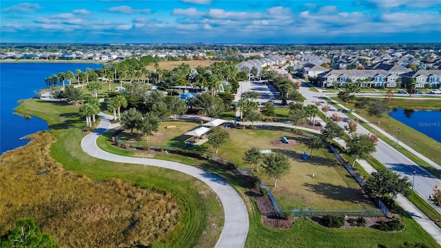 drone / aerial view featuring a water view and a residential view