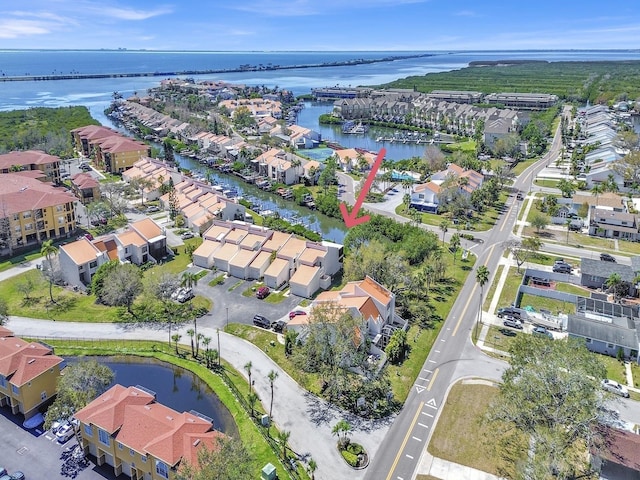 drone / aerial view featuring a water view and a residential view