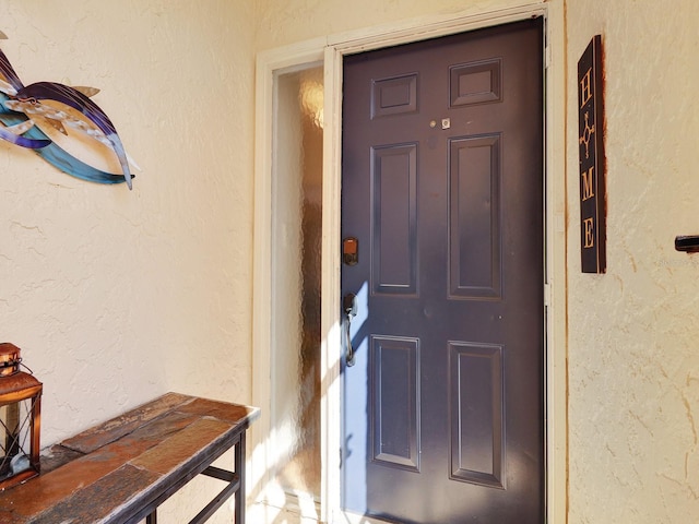 view of exterior entry featuring stucco siding