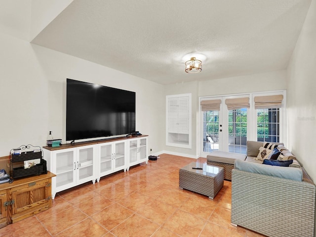 living area with french doors, a textured ceiling, baseboards, and light tile patterned floors