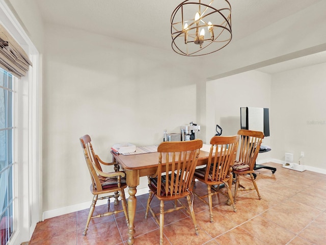 dining space featuring baseboards, tile patterned floors, and an inviting chandelier