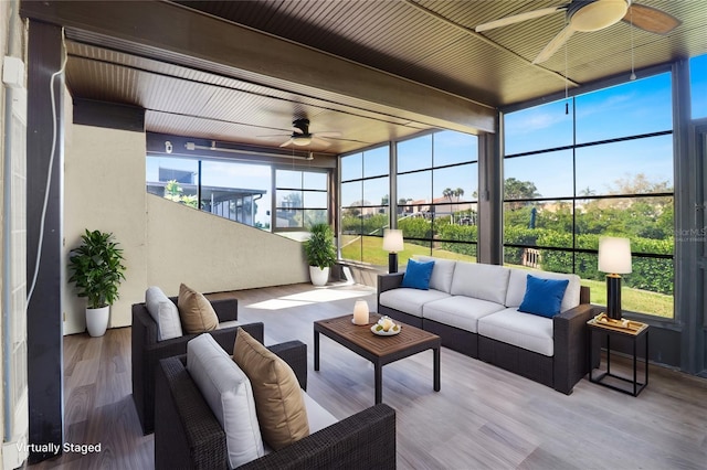 sunroom / solarium with a ceiling fan