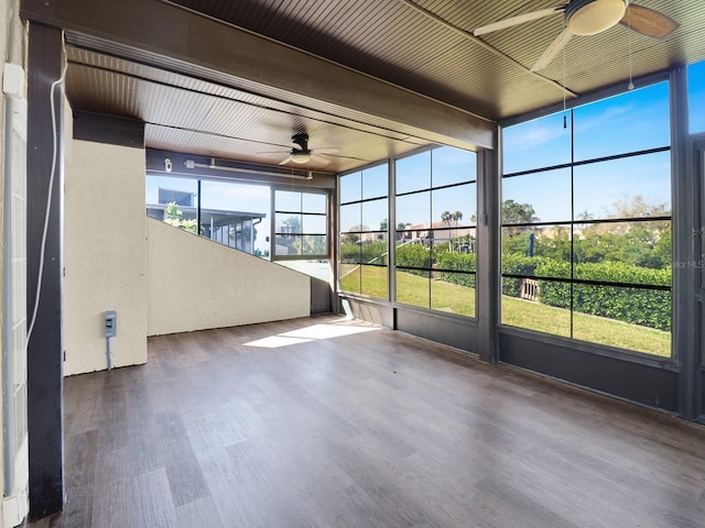 unfurnished sunroom featuring ceiling fan