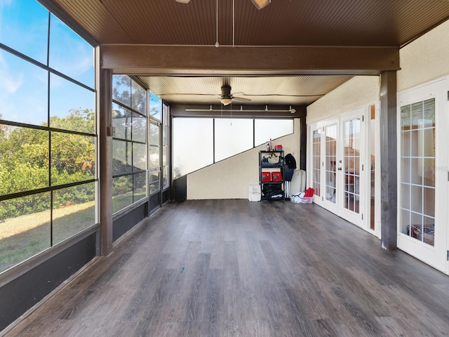 unfurnished sunroom with a wealth of natural light, french doors, and beam ceiling