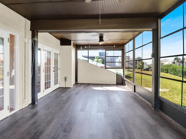 unfurnished sunroom with wood ceiling, beam ceiling, ceiling fan, and french doors