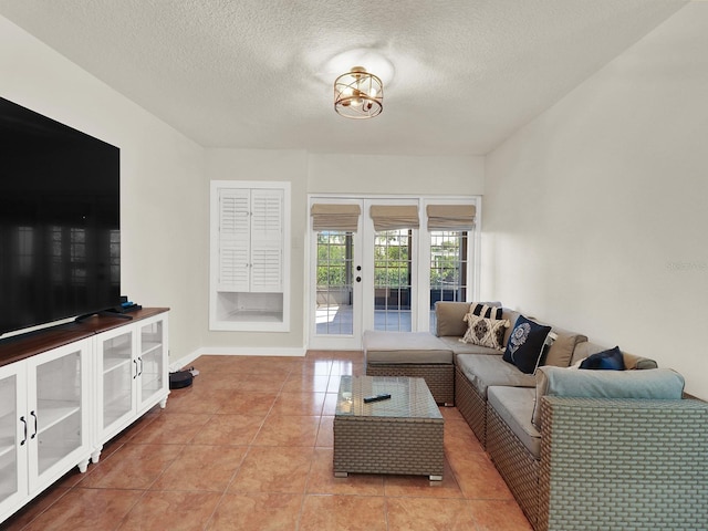 living area with baseboards, light tile patterned flooring, a textured ceiling, and french doors