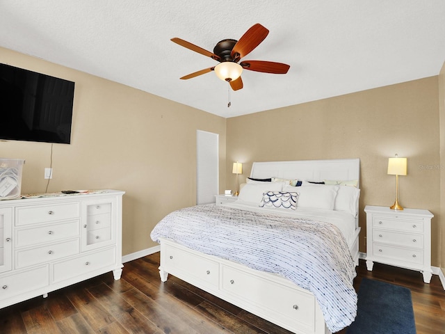 bedroom featuring dark wood-style floors, ceiling fan, and baseboards