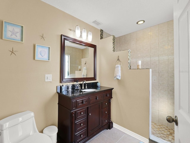 bathroom with visible vents, toilet, vanity, tile patterned flooring, and walk in shower