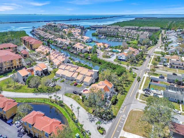 drone / aerial view with a water view and a residential view