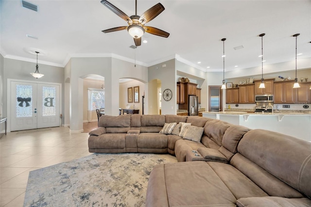 4411 Culbreath Rd, Valrico, FL 33596 - living area featuring visible vents, french doors, arched walkways, light tile patterned floors, and baseboards