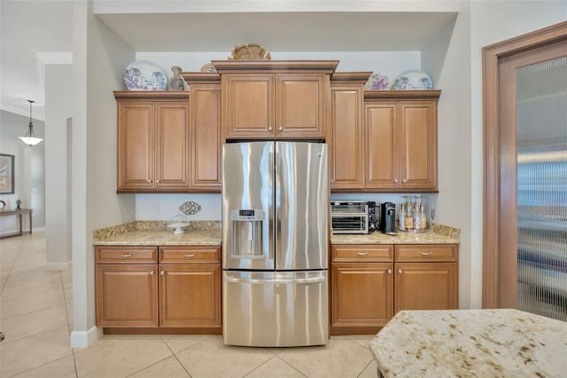 4411 Culbreath Rd, Valrico, FL 33596 - kitchen featuring light stone counters, stainless steel fridge, light tile patterned floors, and brown cabinets