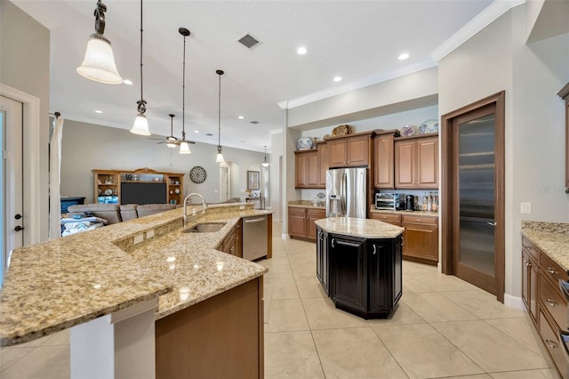 4411 Culbreath Rd, Valrico, FL 33596 - kitchen featuring a large island with sink, a sink, stainless steel appliances, open floor plan, and brown cabinets
