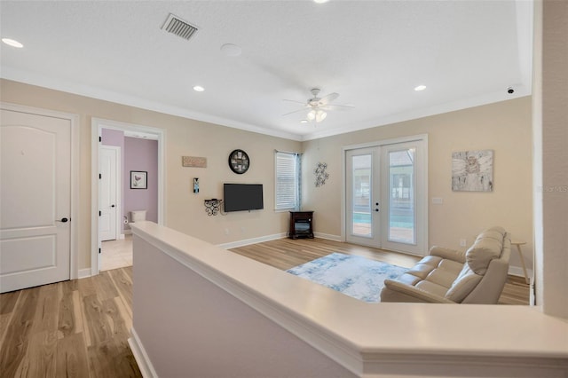 4411 Culbreath Rd, Valrico, FL 33596 - living room featuring visible vents, french doors, light wood-style floors, crown molding, and baseboards