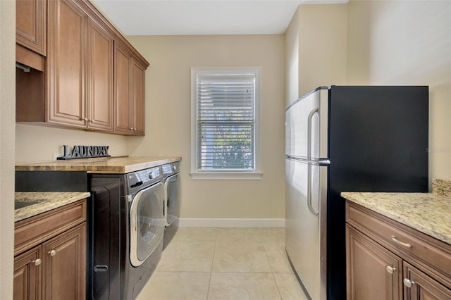 4411 Culbreath Rd, Valrico, FL 33596 - laundry room featuring laundry area, light tile patterned flooring, washing machine and dryer, and baseboards