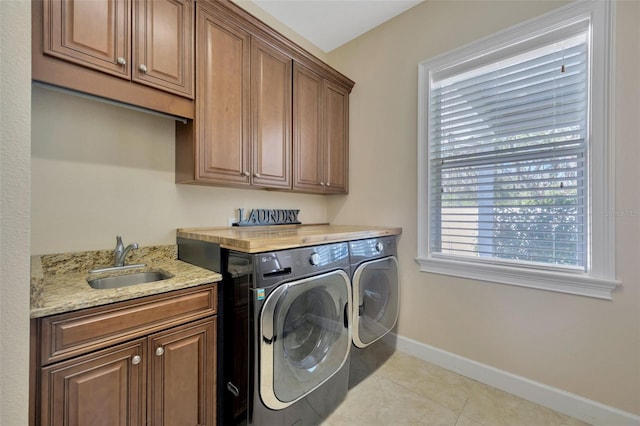 4411 Culbreath Rd, Valrico, FL 33596 - laundry room featuring baseboards, cabinet space, a sink, tile patterned flooring, and washer and clothes dryer