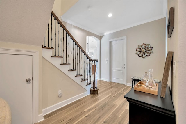 4411 Culbreath Rd, Valrico, FL 33596 - entryway with stairway, arched walkways, light wood-style floors, crown molding, and baseboards