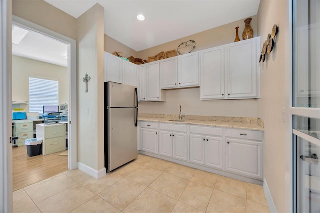 4411 Culbreath Rd, Valrico, FL 33596 - kitchen with a sink, white cabinetry, light tile patterned floors, and freestanding refrigerator