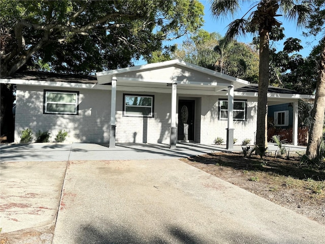 view of front of house with brick siding and a porch