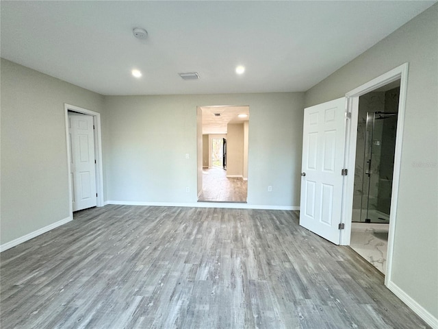 interior space featuring visible vents, recessed lighting, baseboards, and wood finished floors