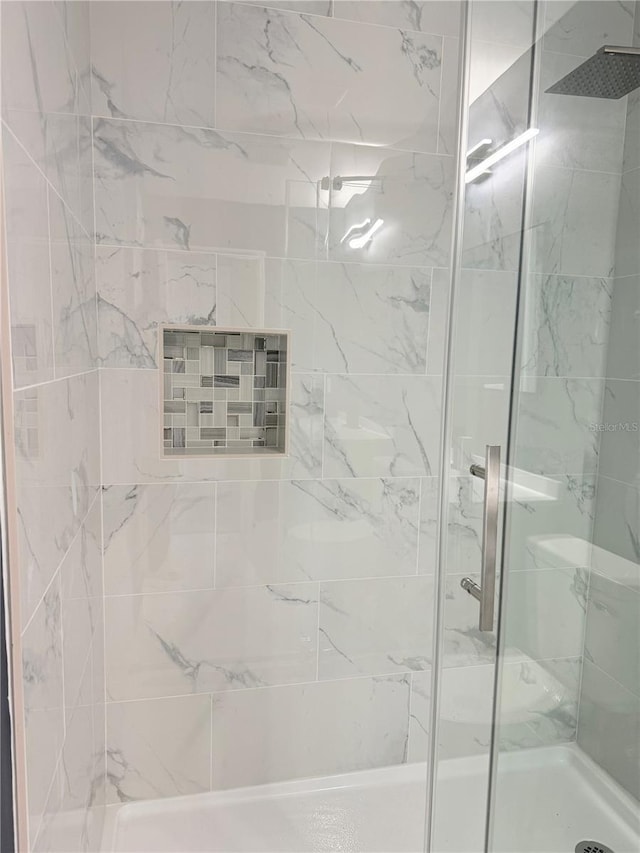 bathroom with a shower stall