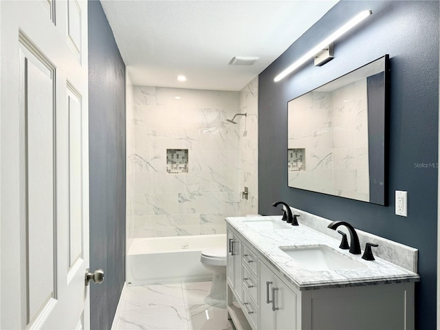 bathroom featuring double vanity, marble finish floor, toilet, and a sink